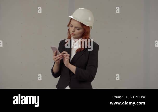 A female architect conducts an inspection of the object and makes notes ...