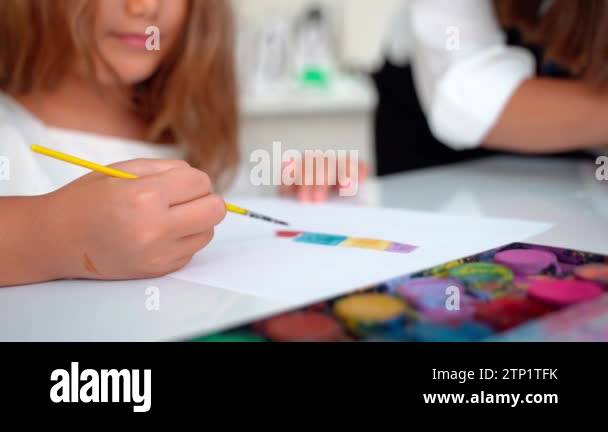 Closeup child paint with watercolor in Art Class Studio with painting ...