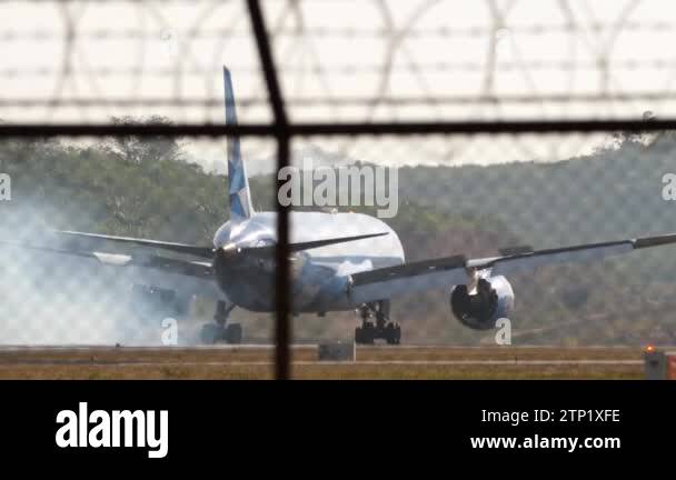 PHUKET, THAILAND - FEBRUARY 19, 2023: Airplane landing on runway back ...