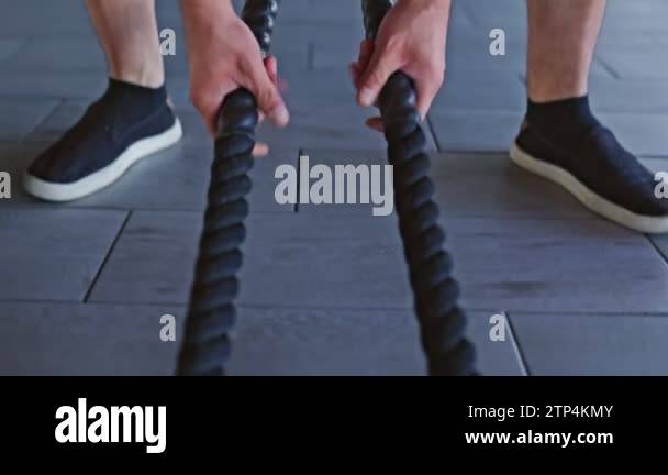 Inside the gym, a young, muscular man showcases his athletic spirit ...