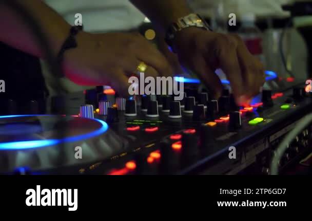 DJ control panel close-up. blurred DJ mixer. Blue light. A mixer in ...