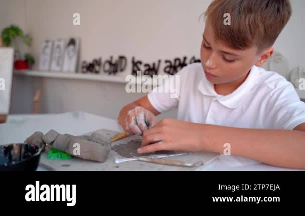 Creating Boy Teen Boy At Art School Clay Sculpt in Art Class. Middle school kid ...