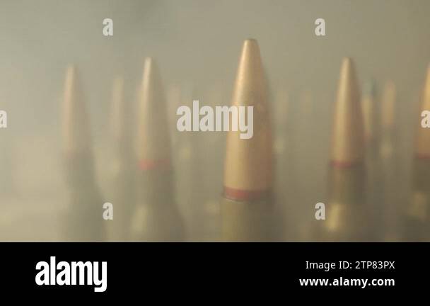 Rows of cartridges for a rifle on a black background close up. Screw ...