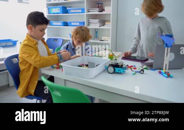 Robotics programming class. Children construct and code Robot. STEM ...