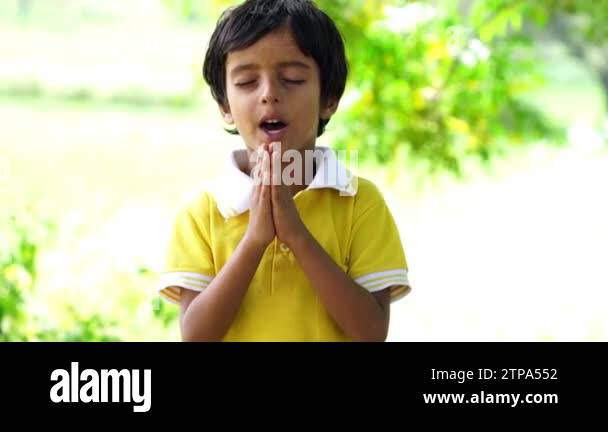Portrait of Happy Indian Boy Praying and worship to God in School. Hand ...
