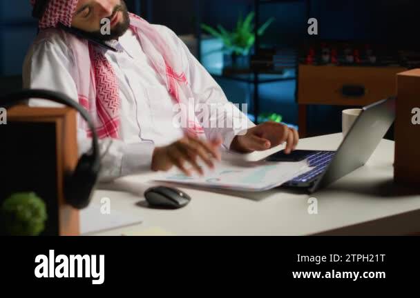 Teleworker Call Working Arabic employee having discussion with coworker in phone call while ...