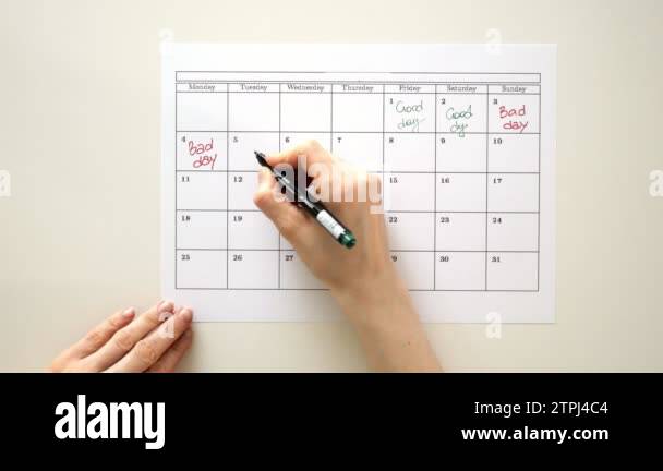 Sign the day in the calendar with a pen, draw a good bad day Stock ...