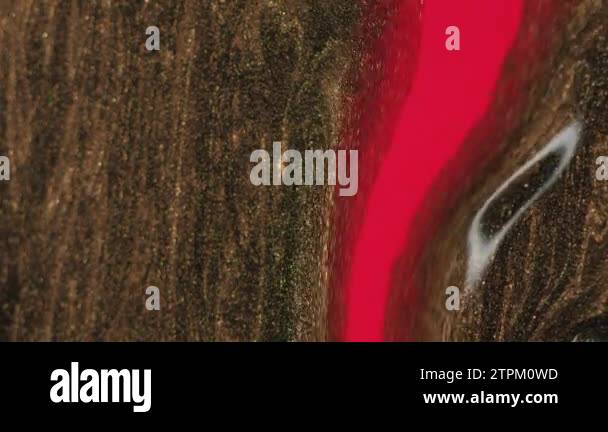 Glitter paint spill. Fluid background. Sparkling liquid. Red golden ...