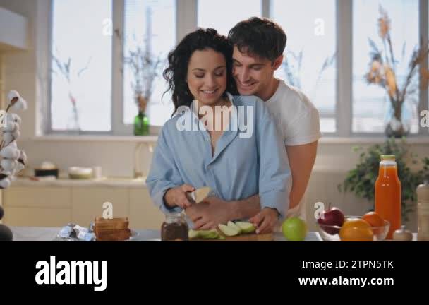 Happy lovers cooking at home hugging enjoy tenderness closeup. Loving ...