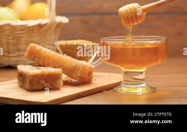 Composition of honey, honeycomb and bee bread. Honey pouring on ...