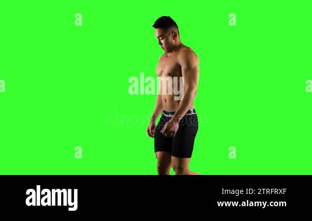 Sportsman walks and runs on a treadmill. Green screen studio Stock