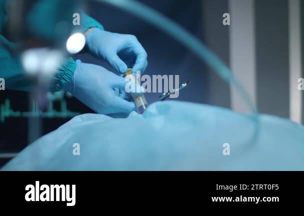 Surgical hands pouring blood in syringe in surgeon room. Surgical ...