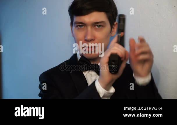 Man gun suit Stock Videos & Footage - HD and 4K Video Clips - Alamy