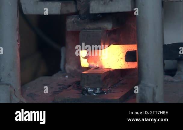 Making the knife out of metal at the forge. Close up blacksmith's hands ...