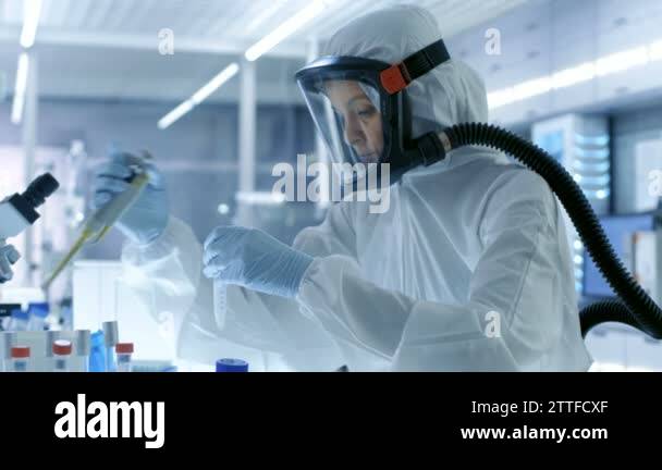 Medical Virology Research Scientist Works in a Hazmat Suit with Mask ...