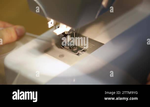 close up mechanism of sewing machine foot with needle and thread. tulle ...
