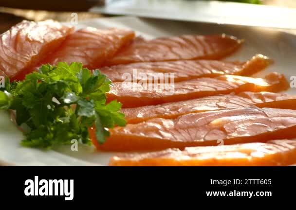 Cut salmon fillets on a cutting board and spread on a plate. Tasty