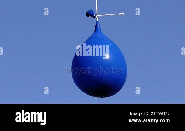 Explosion of balloon full of water on sky background, Full HD video ...
