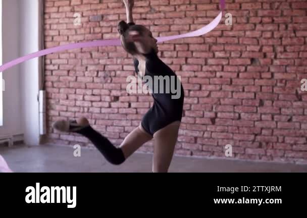 Spining Ribbon Slow motion footage of little gymnastics in black spinning the ribbon ...