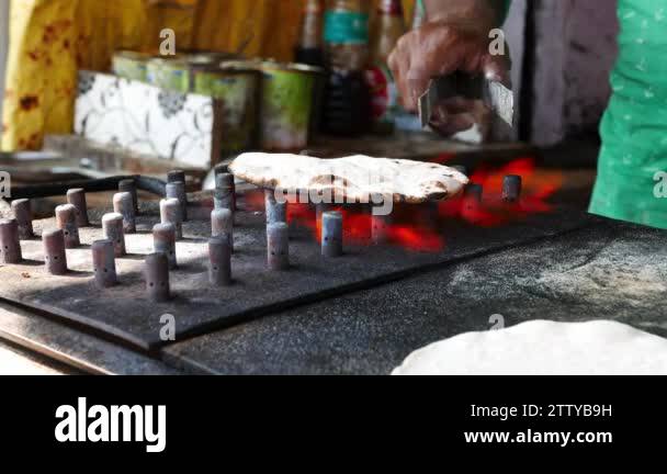 Man cooking Indian flat bread, called chapati roti naan paratha and ...