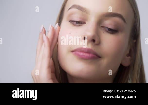 Young Pretty Woman Applies Face Cream On Her Cheekbones Applying Cream