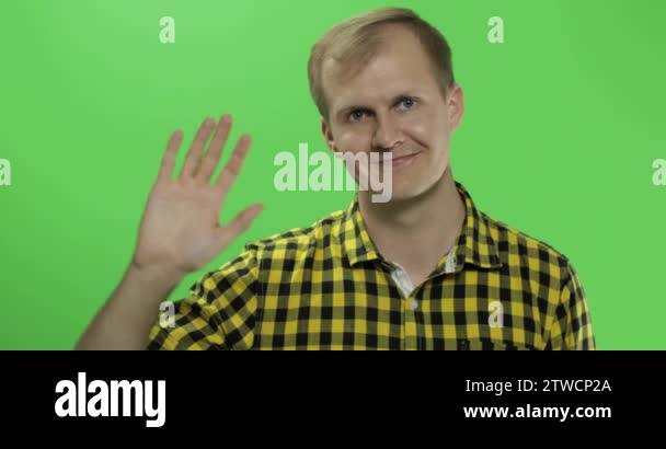 Saluting Screen Handsome caucasian man waves and saluting on green screen chroma key ...