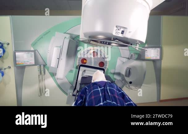 Modern medical equipmnt linear accelerator machine is rotating around a ...