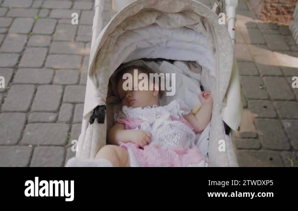 Beautiful little girl sleeping in a baby carriage on the street Stock ...