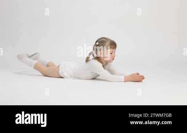 Pretty little girl lying on the floor and doing exercise Stock Video ...