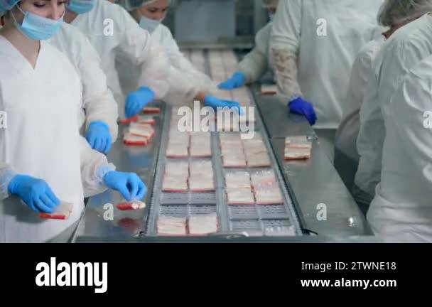 Packing process of crab sticks held by factory workers near factory ...