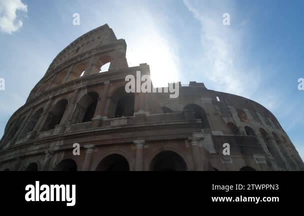 A ray of sun passes through the arches of the Colosseum in Rome, Italy ...
