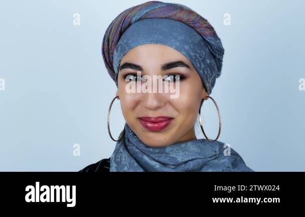 young beautiful arabic woman smiles joyfully on isolated white ...