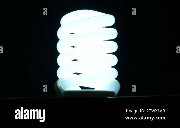 fluorescent lamp turning on and off on black background, slow motion ...