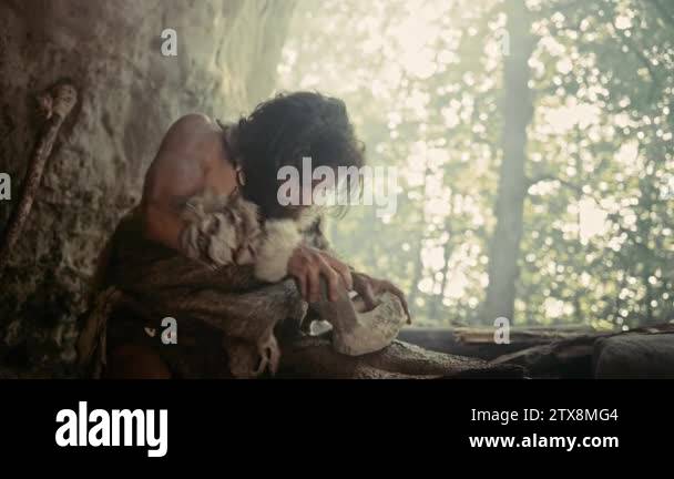 Primeval Caveman Wearing Animal Skin Holds Sharp Stone and Makes First ...
