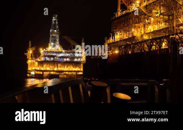 FPSO tanker vessel near Oil platform Rig at night. Offshore oil and gas ...