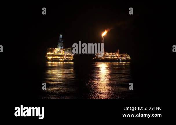 FPSO tanker vessel near Oil platform Rig at night. Offshore oil and gas ...