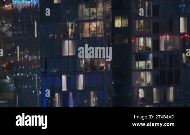 Night view of exterior apartment tower. High rise skyscraper with ...