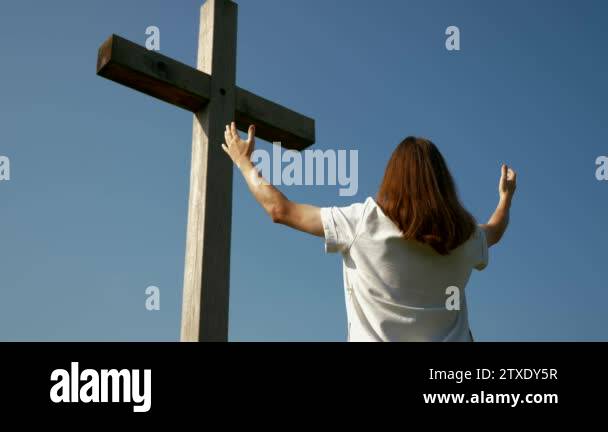 Praying Motion Camera Moves Around Christian Is Praying Before The Cross Holding Hands ...