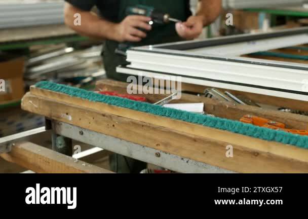 Production and manufacturing of pvc windows, the male worker assembles ...