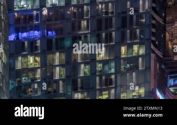 Night view of exterior apartment tower timelapse. High rise skyscraper ...