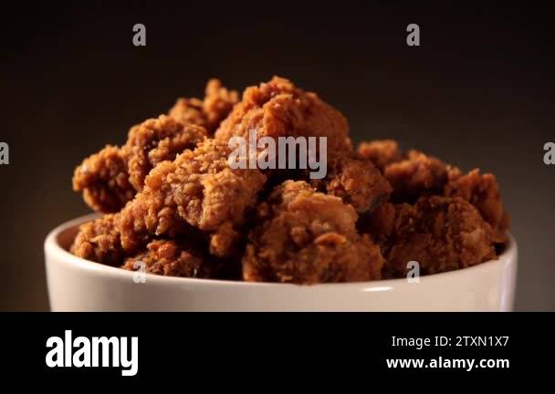 Rotation Bucket full of crispy kentucky fried chicken with smoke on ...