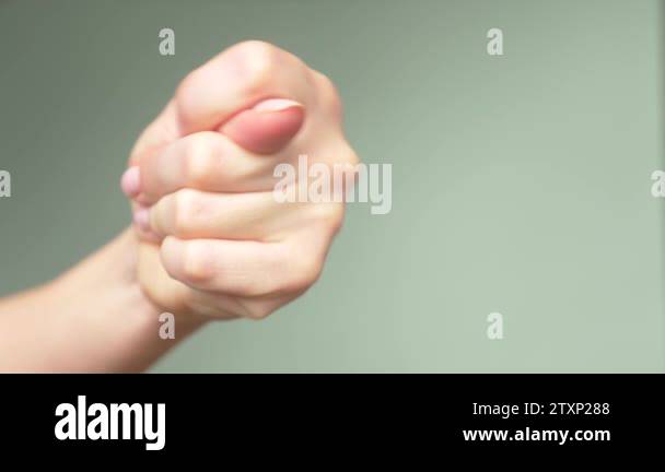 Beautiful Female Hand With Elegant Manicure Shows A Sign Of A Fig Blue
