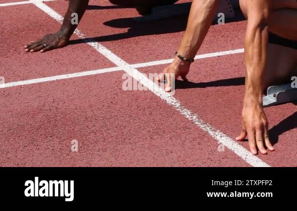 Two Track And Field Athletes At Race Start Stock Video Footage Alamy