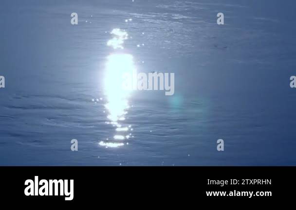 Glare of the sun on the water. Clear sea water, sun sparks on the water ...