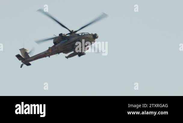 AH-64D Apache Longbow military helicopter attacking targets with canon ...