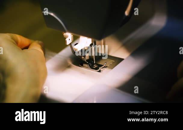 close up mechanism of sewing machine foot with needle and thread. tulle ...
