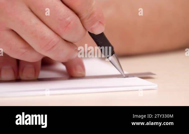 Artist drawing line on white blank. Close shot. Side view. Mans hands ...