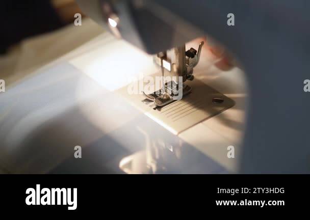 close up mechanism of sewing machine foot with needle and thread. tulle ...