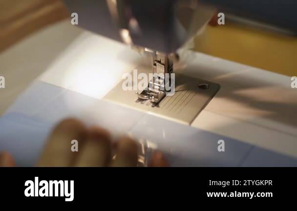 close up mechanism of sewing machine foot with needle and thread. tulle ...