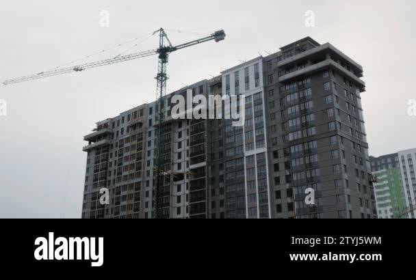 Modern high rise residential complex under construction with huge crane ...